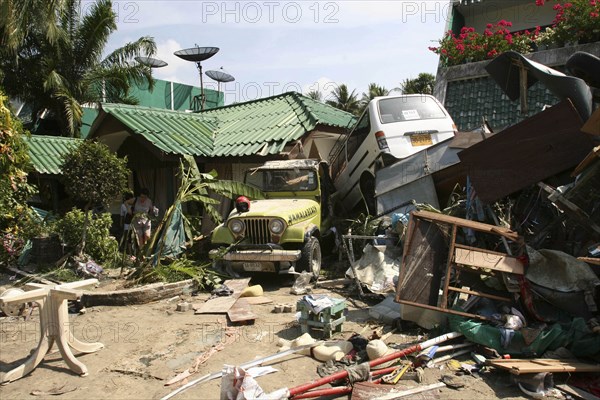 THAILAND, Phang Nga District, Phuket, "Tsunami carnage the day after. Two cars are left in the grounds of the Laonte Hotel. Patong is the busiest part of Phuket with hotels, bars, and shops in a very tightly condensed area, and being peak season had thousands of tourists in the area. On the 27th Dec."