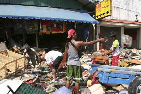 THAILAND, Phang Nga District, Phuket, "Tsunmai carnage the day after. What is left of Patong on the beach road. People go through the rubble to try and find anythng they can salvage of there belongings. Patong is the busiest part of Phuket with hotels, bars, and shops in a very tightly condensed area, and being peak season had thousands of tourists in the area. On the 27th Dec"