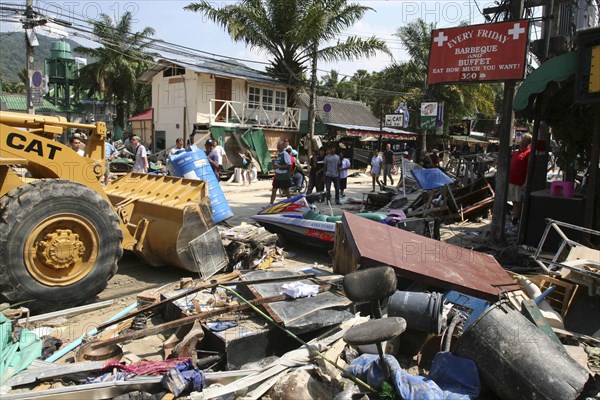 THAILAND, Phang Nga District, Phuket, "Tsunmai carnage the day after. The clean up starts from What is left of some shops and bars at Patong on the beach road. Patong is the busiest part of Phuket with hotels, bars, and shops in a very tightly condensed area, and being peak season had thousands of tourists in the area.  On the 27th Dec"