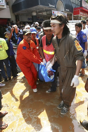 THAILAND, Phang Nga District, Phuket, "Tsunami carnage the day after. Bodies of foreign tourists are brought out of a flooded supermarket which was in the basement. Patong is the busiest part of Phuket with hotels, bars, and shops in a very tightly condensed area, and being peak season had thousands of tourists in the area. On the 27th Dec."