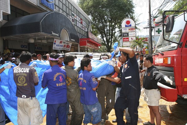 THAILAND, Phang Nga District, Phuket, "Tsunami carnage the day after. Bodies of foreign tourists are brought out of a flooded supermarket which was in the basement along Patong Beach Road by rescue workers. Patong is the busiest part of Phuket with hotels, bars, and shops in a very tightly condensed area, and being peak season had thousands of tourists in the area.  On the 27th Dec"