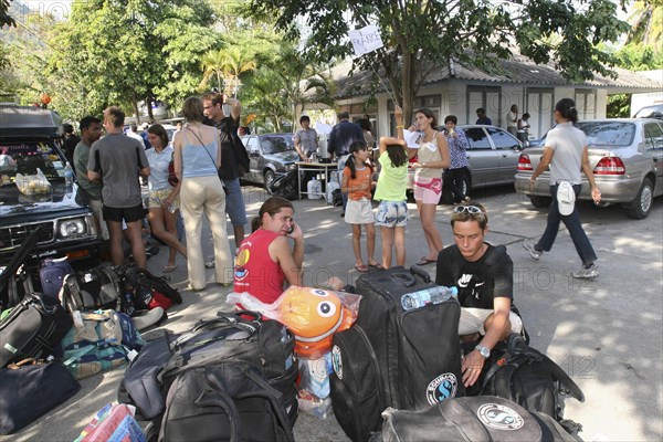 THAILAND, Phang Nga District, Phuket, Tsunami carnage the day after. The Town Hall in Phuket town is being used as a shelter for the people who have no where to go. People wait as they have lost there passports and money. On the 27th Dec