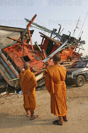 THAILAND, Phang Nga District, Nam Khem, "Tsunami. Monks looks at the damage caused by the tsunami, nothing is left standing in the village 2500 people are pressumed dead. 125kms north of Phuket on the 2nd Jan"