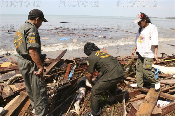 THAILAND, Phang Nga District, Khao Lak Beach, Tsunami. Rescue workers help to collect the bodies which have been floating out at sea and lying along the coastline. Bodies that were out at sea now litter the coastline. Now the devestation can be seen in the remote areas. This was about 60kms north of Phuket where the whole coastline looks like this and bodies are being found all the way along the coastline. On the 28th Dec