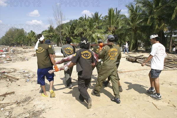 THAILAND, Phang Nga District, Khao Lak Beach, "Rescue workers collect Bodies that were out at sea and now litter the coastline. Now the devestation can be seen in the remote areas. This was about 60kms north of Phuket at Khaolak Beach with the destruction of Khaolak Resort behind, where the whole coastline looks like this and bodies are being found all the way along. On the 28th Dec."