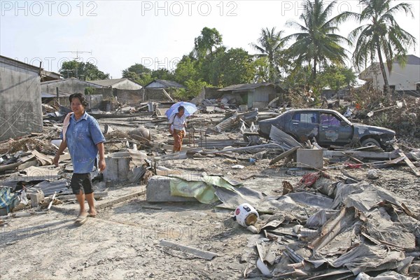 THAILAND, Phang Nga District, Nam Khem, "Tsunami. Thais walk through what is left of there vilage, nothing is left standing in the village of Nam Kem, about 125kms north of Phuket. In Phangnga district. On the 31st Dec."