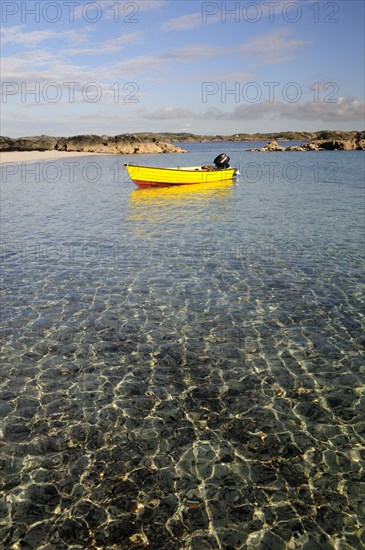SCOTLAND, Argyll, Isle Of Mull, Yellow boat anchored in clear waters wide angle