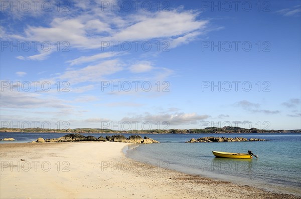 SCOTLAND, Argyll, Isle Of Mull, Sandy beach & clear waters with yellow boat anchored near shoreline