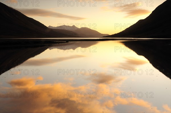 Scotland, Argyll, Loch Etive, Sunset coloured clouds reflected in Loch Etive