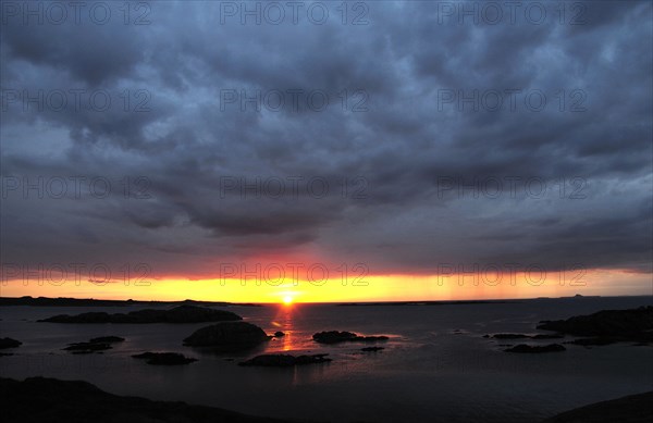 Scotland, Argyll, Isle Of Mull, Sunset over small islands and north tip of Iona