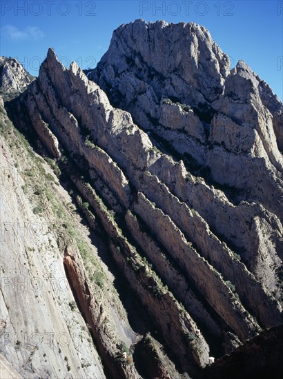 SPAIN, Catalonia, Lleida, Near vertical strata of crumbling limestone rock along Rio Noguera Ribagorcana.