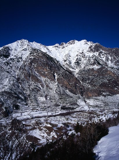 SPAIN, Aragon, Pyrenees, Snow covered mountain group including Tuca 2902 metres 9504 feet which is 2837 metres 9291 feet from the road towards ski village of Celer above the town of Benasque.