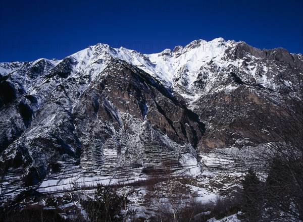 SPAIN, Aragon, Pyrenees, Snow covered mountain group including Tuca 2902 metres 9504 feet which is 2837 metres 9291 feet from the road towards ski village of Celer above town of Benasque