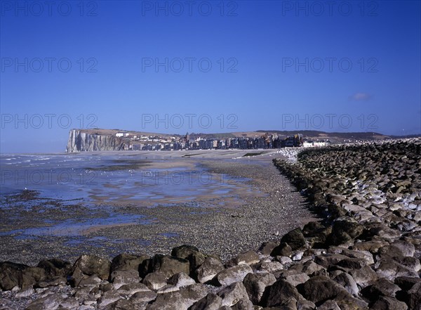 FRANCE, Normandy, Mers les Bains, View north east along shoreline by the town Mers les Bains. Chalk cliffs beyond and tide out.