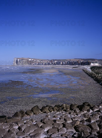 FRANCE, Normandy, Mers les Bains, View north east along shoreline by town Mers les Bains. Chalk cliffs beyond and tide out.