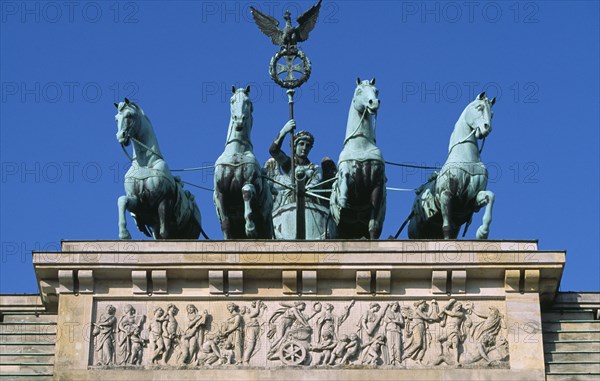 GERMANY, Berlin, "The Brandenburg Gate. The Quadriga on top of the gate. Chariot drawn by four horses driven by Victoria, Roman goddess of victory."