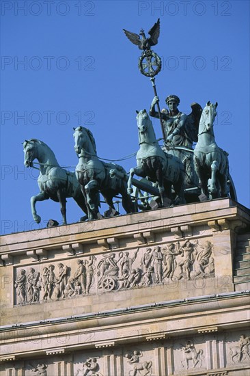 GERMANY, Berlin, "The Brandenburg Gate.  Angled view of the Quadriga on top of the gate.  Chariot drawn by four horses driven by Victoria, Roman goddess of victory."