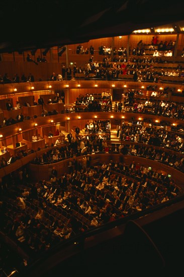 ENGLAND, East Sussex, Glyndebourne, Interior of auditorium with attendees taking their seats before Opera performance.