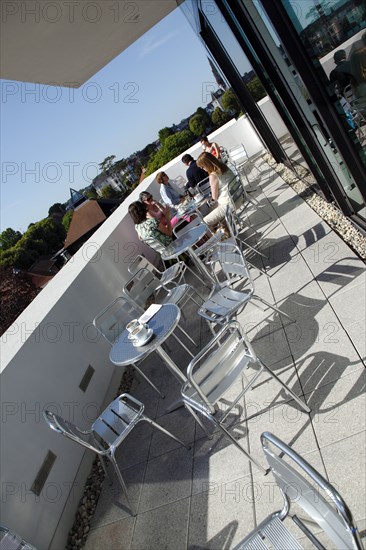 ENGLAND, East Sussex, Eastbourne, Towner Gallery building balcony outside the cafe area with visitors drinking coffee.