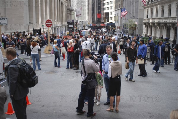 USA, New York, Manhattan, "Financial District, Wall Street, Crowds of people and news reporter television crews outside the NY Stock Exchange building."