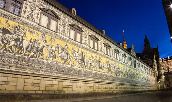 GERMANY, Saxony, Dresden, "Frstenzug or Procession of the Dukes at sunset in Auguststrasse a mural on 25,000 Meissen tiles that depicts 35 noblemen from the 12th century Konrad the Great, to Friedrich August III, Saxony's last king, who ruled from 1904-1918. It was originally painted by Wilhelm Walter between 1870 and 1876 but eventually, the stucco began to crumble and around 1906-'07 it was replaced by the tiles."