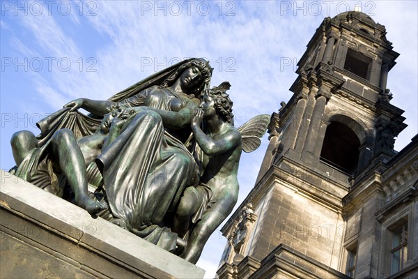 GERMANY, Saxony, Dresden, Bronze statue of a woman and winged angels on the Bruhl Terrace beside the tower of the Neues Standehaus.