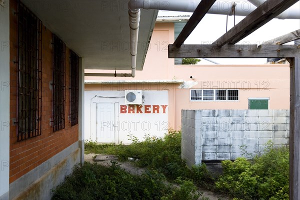 WEST INDIES, St Vincent & The Grenadines, Union Island, Derelict bakery set amongst waste ground in Clifton.