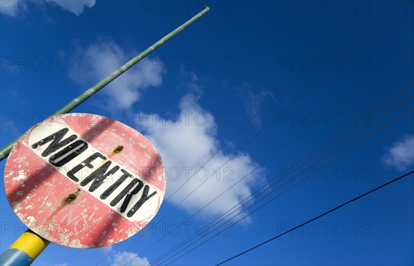 WEST INDIES, St Vincent & The Grenadines, Union Island, Colourful and weather worn No Entry road sign in Clifton.