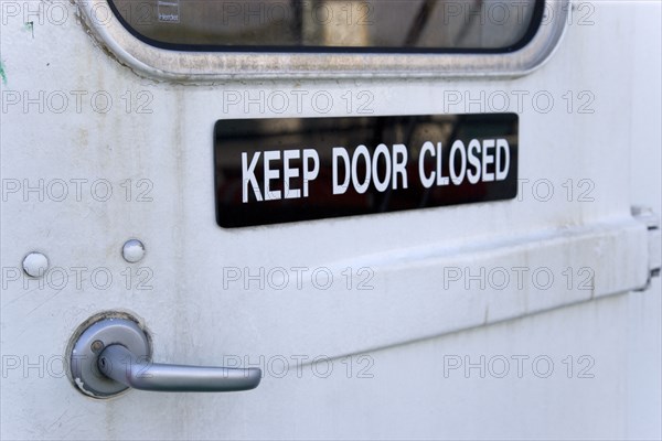 WEST INDIES, St Vincent & The Grenadines, Kingstown, Sign on a door of an inter island ferry ship that reads Keep Door Closed.