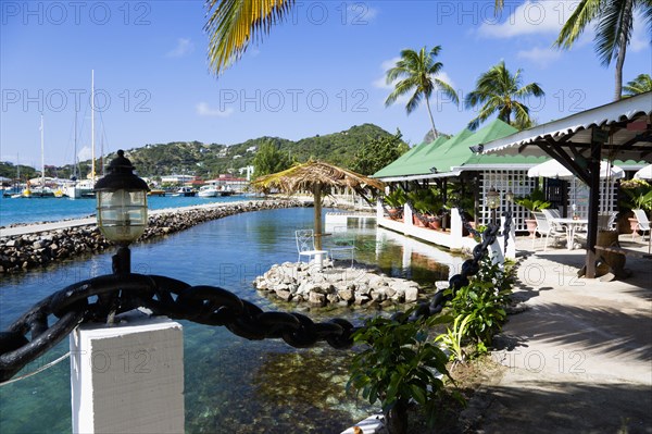 WEST INDIES, St Vincent & The Grenadines, Union Island, The capital of Clifton and the harbour seen from the terrace of the Anchorage Yacht Club restaurant and bar beside the shark pool.
