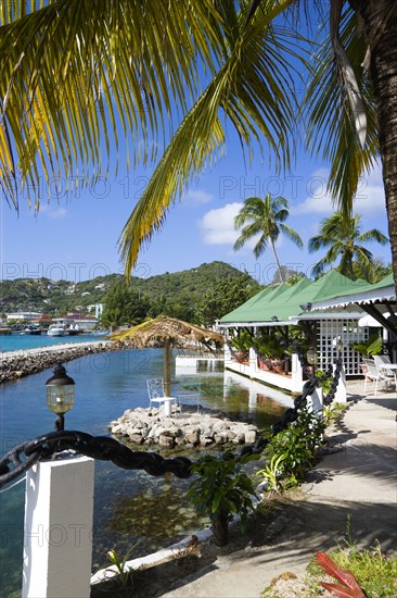 WEST INDIES, St Vincent & The Grenadines, Union Island, The capital of Clifton and the harbour seen from the terrace of the Anchorage Yacht Club restaurant and bar beside the shark pool.