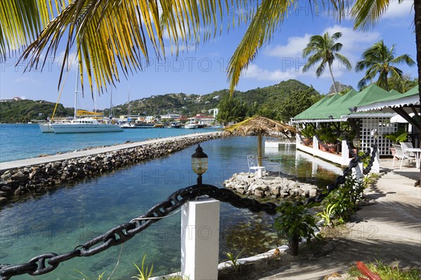 WEST INDIES, St Vincent & The Grenadines, Union Island, The capital of Clifton and the harbour seen from the terrace of the Anchorage Yacht Club restaurant and bar beside the shark pool.