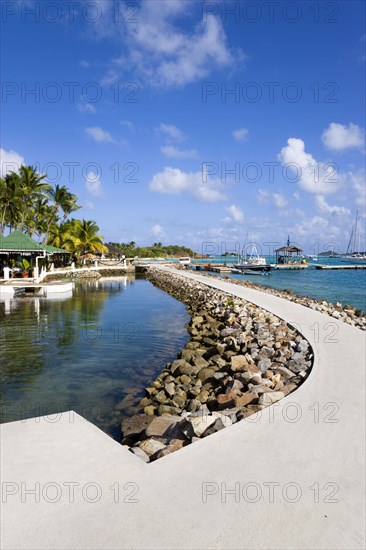 WEST INDIES, St Vincent & The Grenadines, Union Island, The walkway and shark pool beside the bar and restaurant of the Anchorage Yacht Club in Clifton Harbour.
