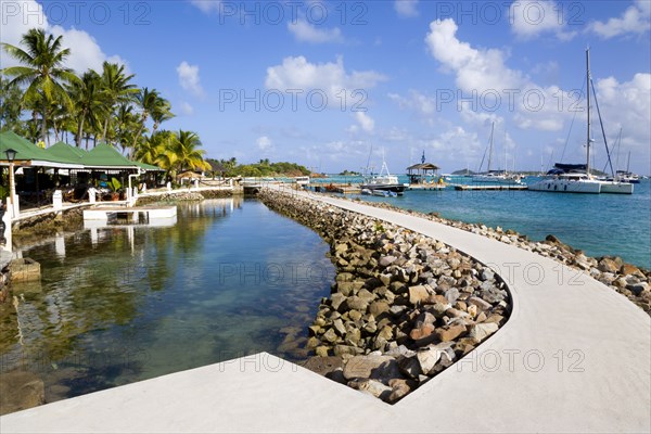 WEST INDIES, St Vincent & The Grenadines, Union Island, The walkway and shark pool beside the bar and restaurant of the Anchorage Yacht Club in Clifton Harbour.