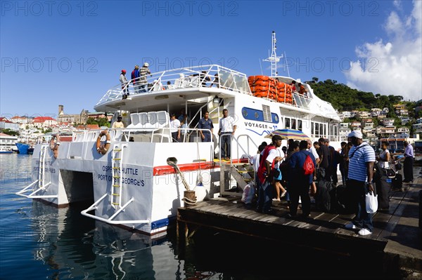 WEST INDIES, Grenada, St Georges, The Osprey Shuttle catamaran inter island service in the Carenage with passengers boarding in the morning for Carriacou and Petit Martinique.