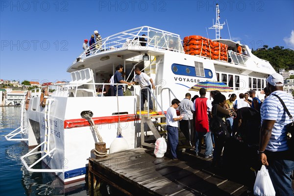 WEST INDIES, Grenada, St Georges, The Osprey Shuttle catamaran inter island service in the Carenage with passengers boarding in the morning for Carriacou and Petit Martinique.