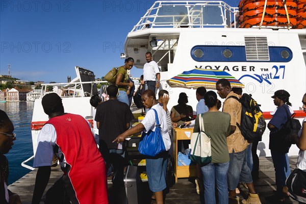 WEST INDIES, Grenada, St Georges, The Osprey Shuttle catamaran inter island service in the Carenage with passengers boarding in the morning for Carriacou and Petit Martinique.