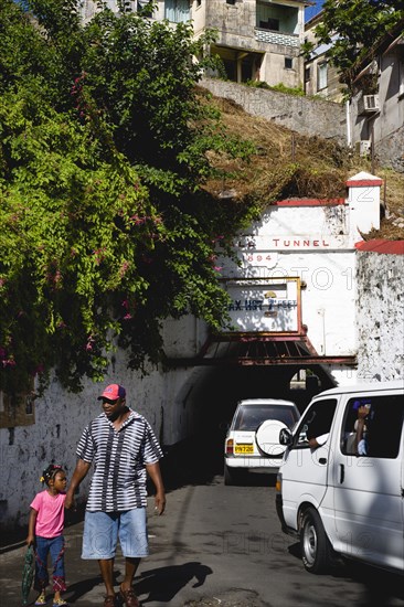 WEST INDIES, Grenada, St Georges, The Sendall Tunnel built in 1894 with pedestrians and cars moving through it.