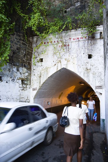 WEST INDIES, Grenada, St Georges, The Sendall Tunnel built in 1894 with pedestrians and cars moving through it.