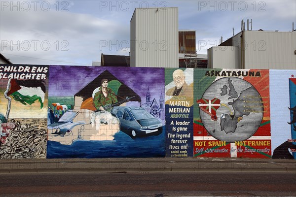 IRELAND, North, Belfast, "West, Falls Road, Political murals painted on walls of the Lower Falls Road area depicting MArtin meehan from Ardoyne and an unfinished mural showing the famous Black Taxi buses"