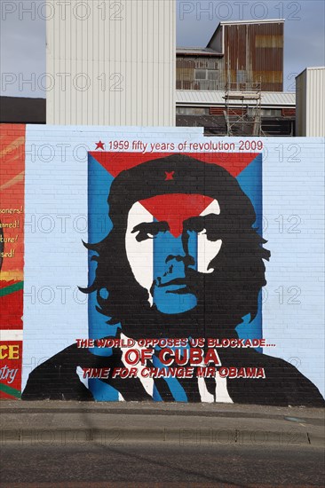 IRELAND, North, Belfast, "West, Falls Road, Political murals painted on walls of the Lower Falls Road area showing Ernesto Che Guevara with an anti US blockade message."
