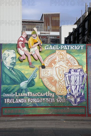 IRELAND, North, Belfast, "West, Falls Road. Mural depicting Liam McCarthy and some people playing Hurling"