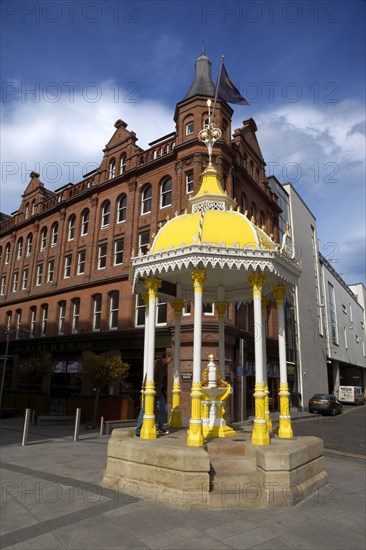 IRELAND, North, Belfast, "Victoria Square, Yellow coloured Victorian Jaffe drinking fountain outside the entrance to the shopping centre. Stephen Rafferty"