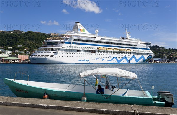 WEST INDIES, Grenada, St George, Cruise ship liner Aida Aura and local tourist boat moored on either side of the Carenage in the harbour.