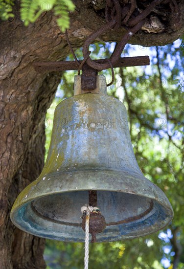 WEST INDIES, Grenada, St Patrick, The bell hanging from a tree at Belmont Estate Plantation originally used to call the slaves from the fields.