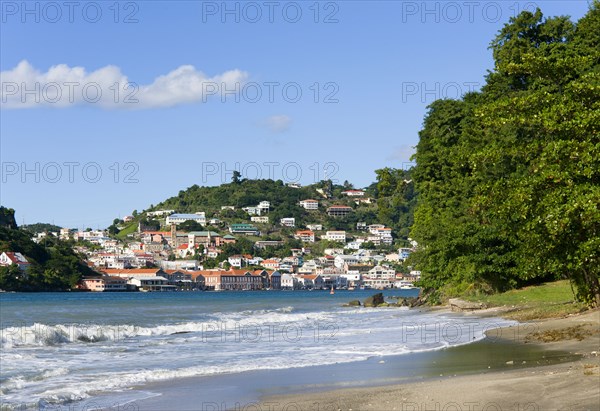 WEST INDIES, Grenada, St George, The hillside buildings and waterfront of the Carenage in the capital St Georges seen from Pandy Beach beside Port Louis Marina.