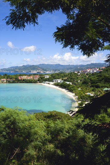 WEST INDIES, Grenada, St George, BBC Beach in Morne Rouge Bay lined with holiday apartments with the capital of St Georges in the distance.