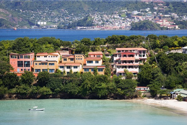 WEST INDIES, Grenada, St George, BBC Beach in Morne Rouge Bay lined with holiday apartment villas and the capital of St Georges in the distance.