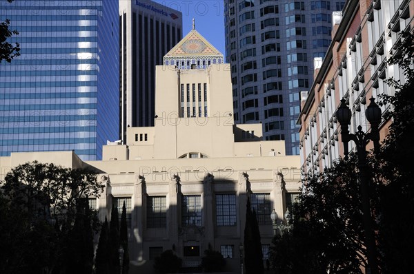 USA, California, Los Angeles, LA Central library dwarfed by sky scrapers of financial district