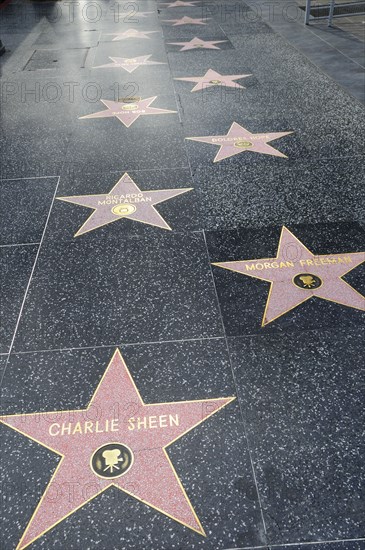 USA, California, Los Angeles, "Hollywood Walk of Fame along Hollywood Boulevard showing stars of Charlie Sheen, Morgan Freeman & Ricardo Montalban."